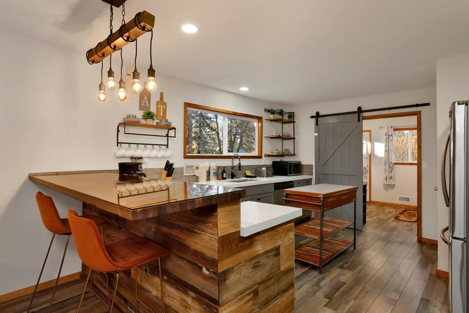 Fully equipped cabin kitchen with ample cabinetry, stove, fridge, microwave, and coffee maker—perfect for cooking meals, morning coffee, and feeling right at home on your stay.