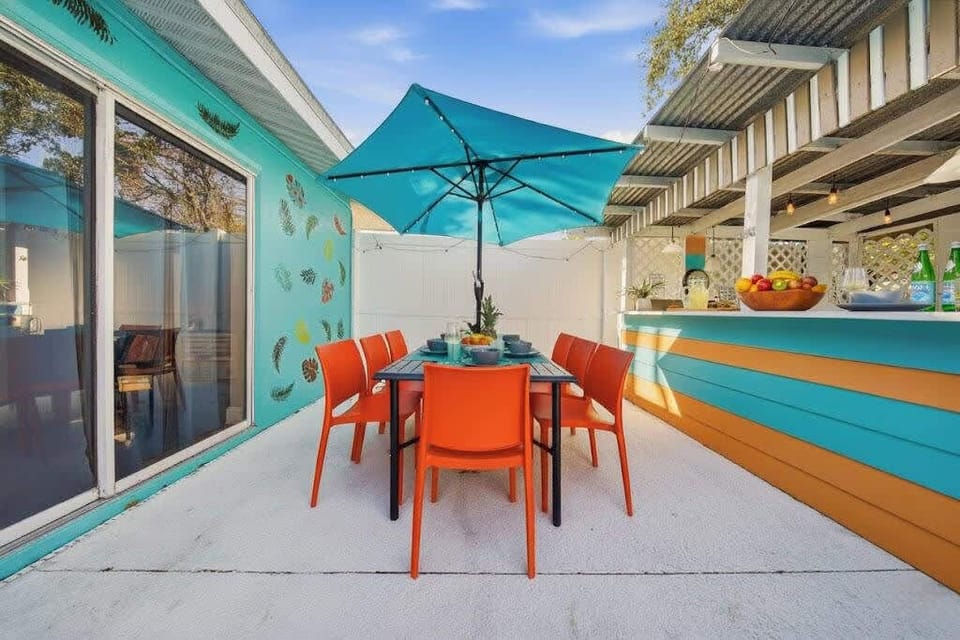 Dine al fresco in your private tropical oasis! 🌴 Enjoy our vibrant outdoor bar, shaded patio, and neon game room. Perfect for families near Anna Maria Island. Your dream Bradenton getaway awaits! Book your family retreat! ☀️ #FloridaTravel #Family