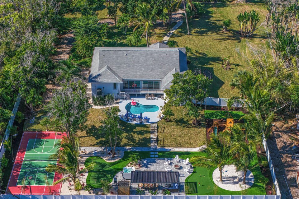 Outdoor Paradise: Dive into fun with a sparkling pool and vibrant sports courts in lush tranquility!