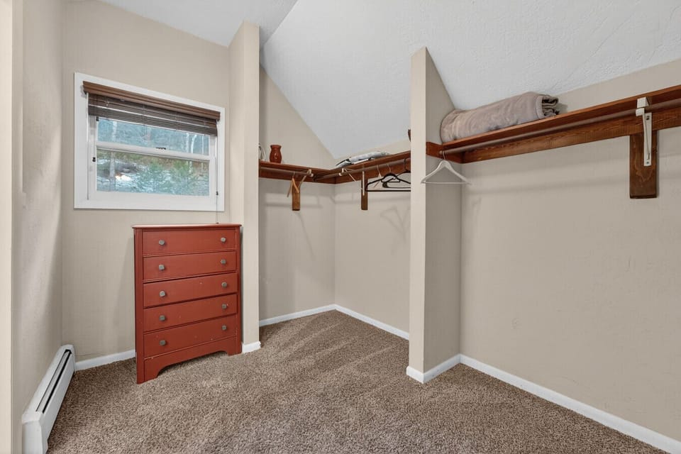 A spacious closet linking the bedroom directly to the private bathroom.