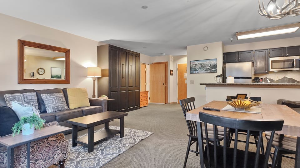 Open-plan space connecting dining, living, and kitchen areas.