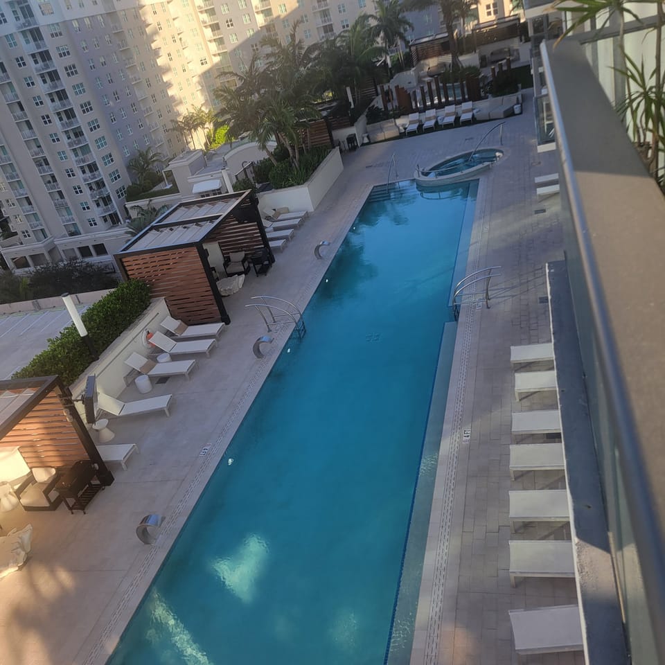 Pool area with cabanas leading to cold plunge, sauna steam room and zen area  