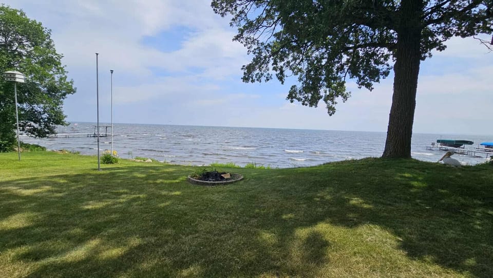 Peaceful lakeside setting with a private dock and firepit—perfect for relaxing under the shade or enjoying stunning water views
