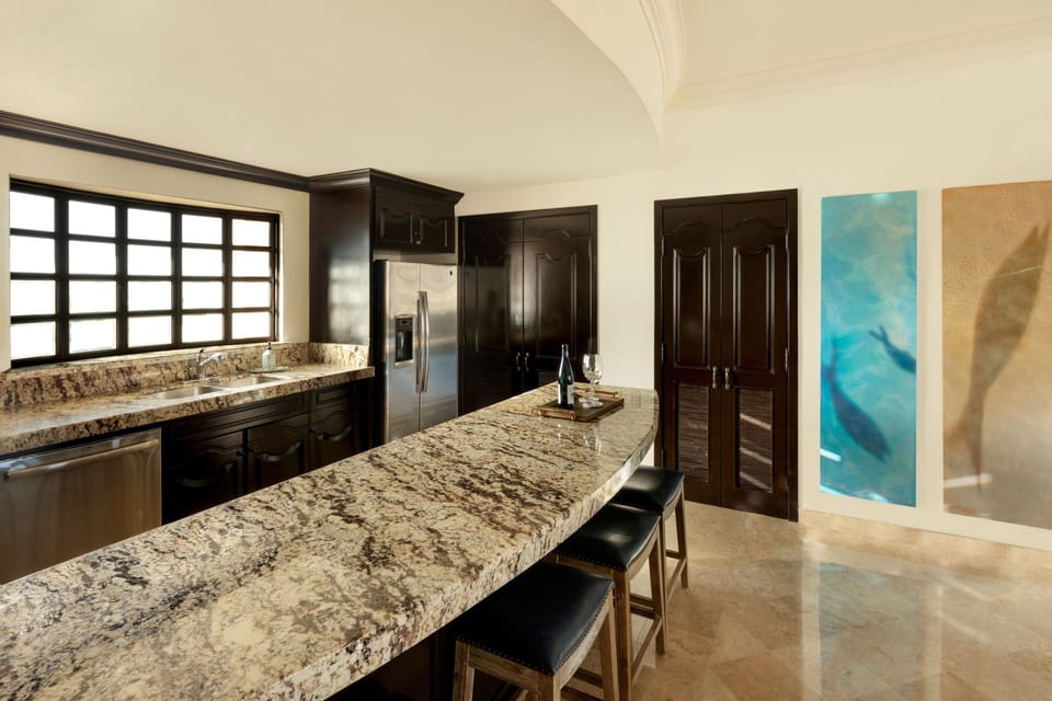 Contemporary kitchen with quality appliances, granite counters, and ample space 