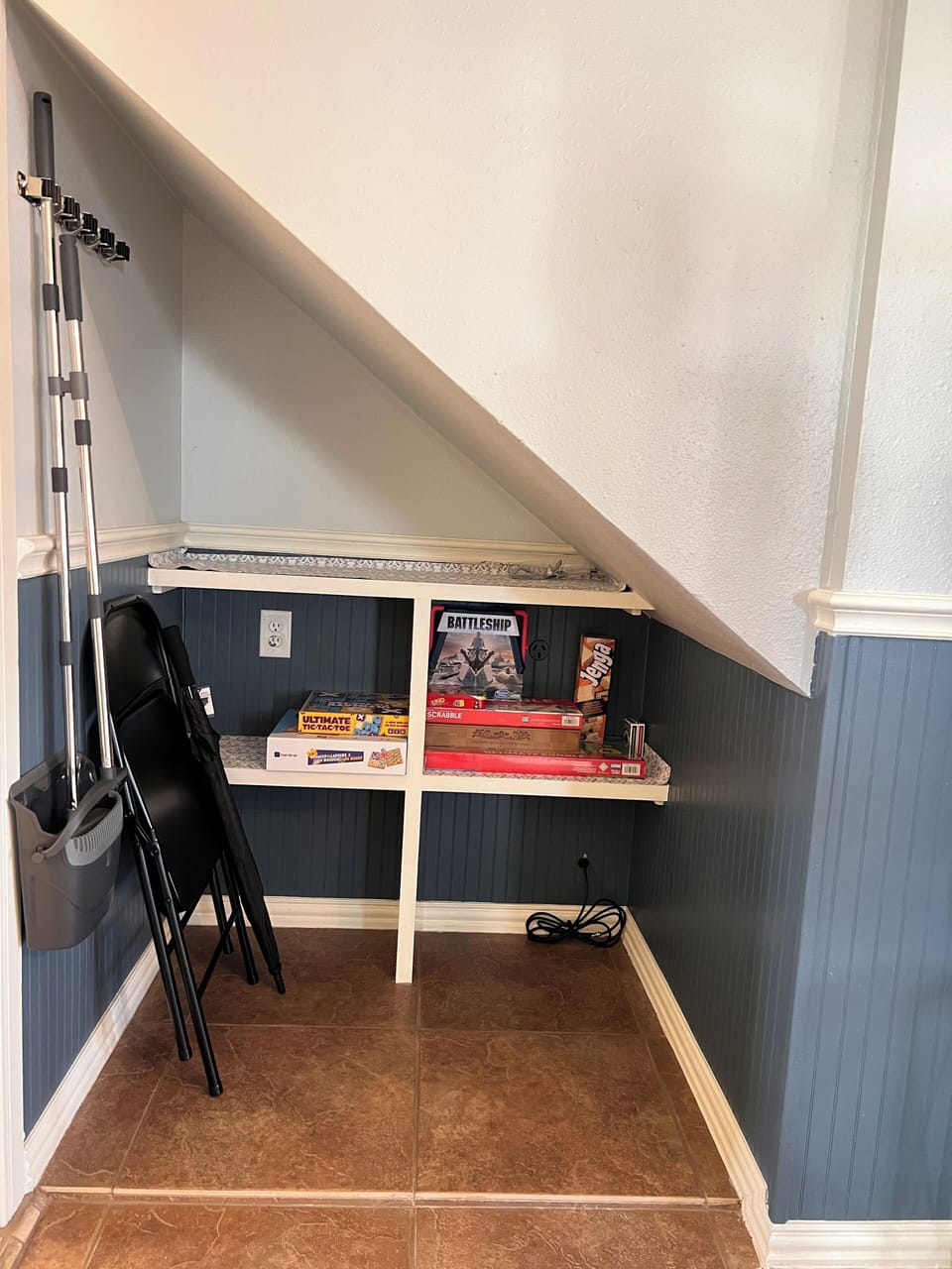 Extra storage and game area under stairs keeps living space organized.