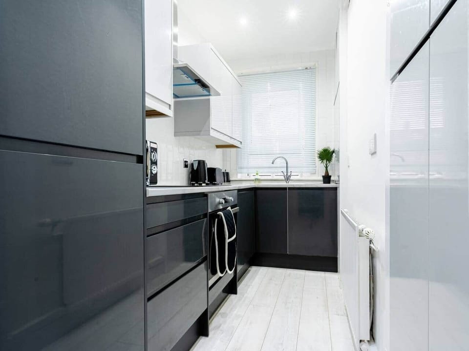 The kitchen has a contemporary and stylish aesthetic that seamlessly integrates with the overall ambiance of the house. Clean lines, minimalist decor, and high-quality materials create an inviting space that is both visually striking and practical.