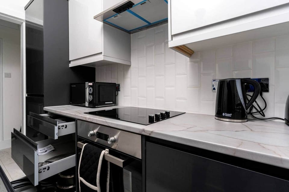 The kitchen has a contemporary and stylish aesthetic that seamlessly integrates with the overall ambiance of the house. Clean lines, minimalist decor, and high-quality materials create an inviting space that is both visually striking and practical.