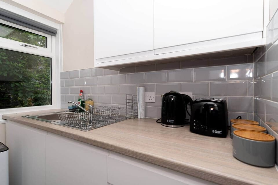 The kitchen has a contemporary and stylish aesthetic that seamlessly integrates with the overall ambience of the house. Clean lines, minimalist decor, and high-quality materials create an inviting space that is both visually striking and practical.