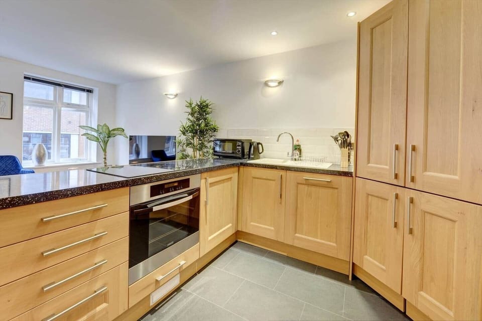 The kitchen has a contemporary and stylish aesthetic that seamlessly integrates with the overall ambiance of the house. Clean lines, minimalist decor, and high-quality materials create an inviting space that is both visually striking and practical.