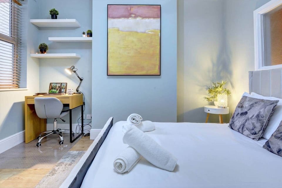 Bedroom has a double bed in a room converted into a dedicated sleeping area. A privacy partition is in place to provide separation when the space is used as a sleeping area. Notably, this room also serves as a passage to both the lounge and kitchen. 