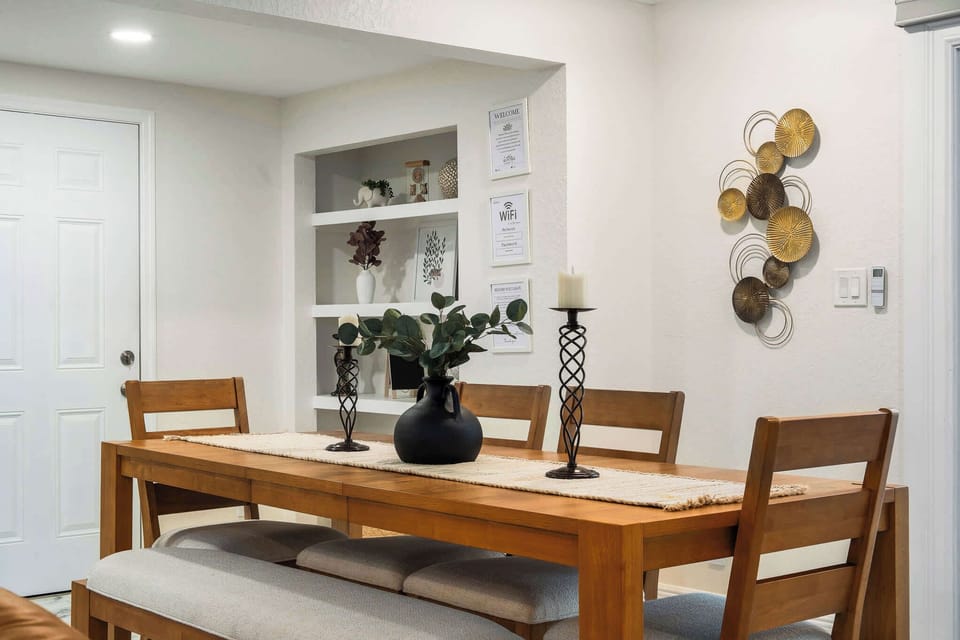 Share meals in this cozy dining nook featuring a warm wooden table, comfortable seating, and charming décor. A welcoming space for family dinners, game nights, or planning the day’s adventures together.