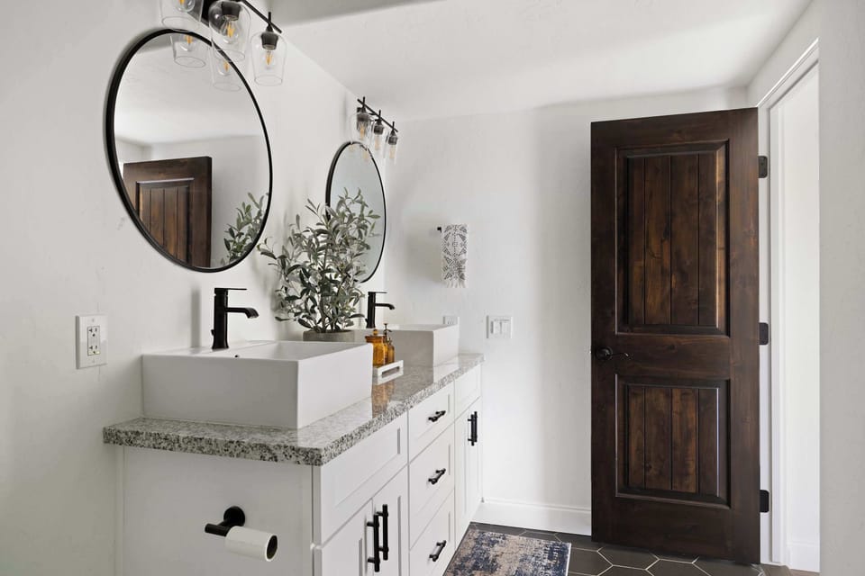 Freshen up in a stylish bathroom featuring a modern vanity and thoughtful finishes.