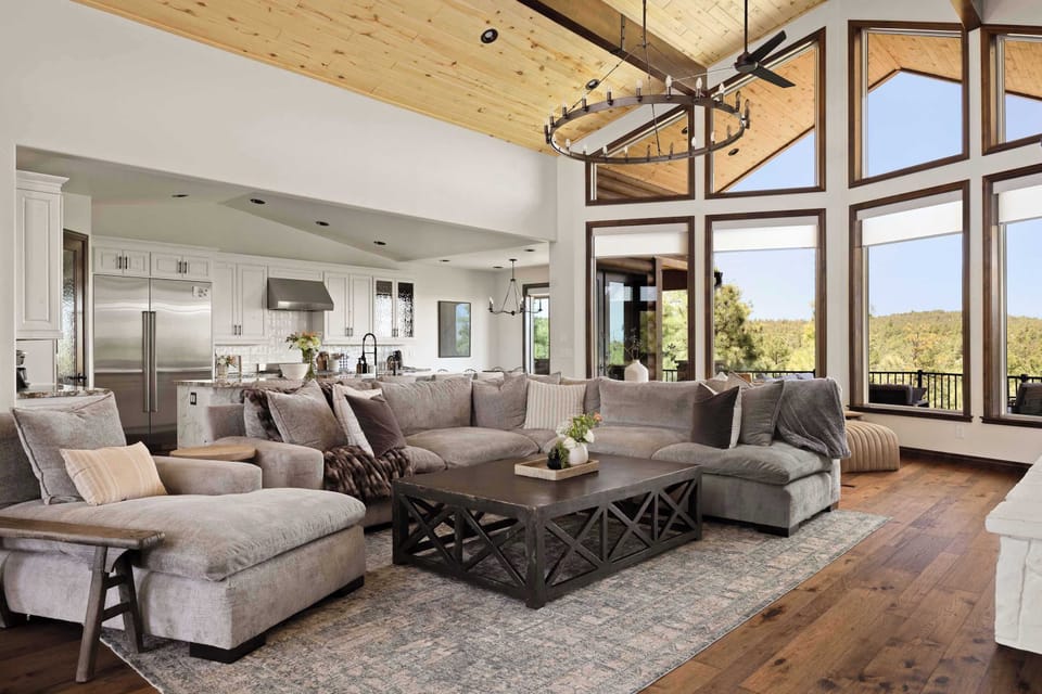 Stretch out by the fireplace while enjoying mountain views through the cabin's soaring windows.