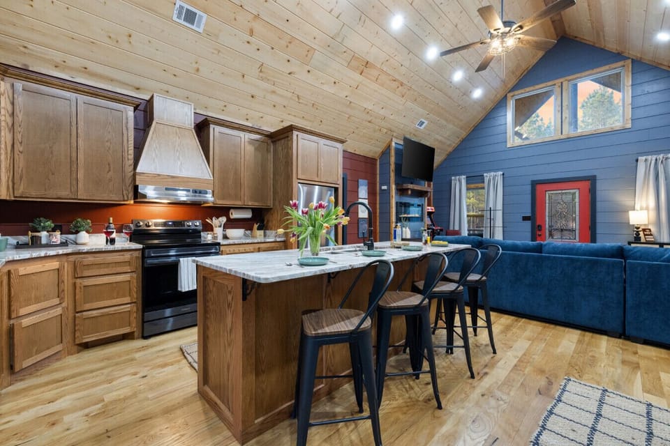 Cook and hang together in the open kitchen—big island seating, fully stocked setup, and plenty of room for group meals (then straight back to the hot tub). Easy hosting, vacation-level comfort.