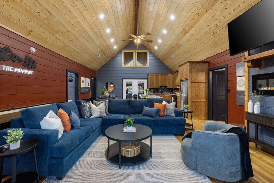 Bring everyone together in the open‑concept great room—vaulted wood ceilings, big sectional seating, and space to play, stream, and reconnect. This is where game nights and slow mornings naturally happen.