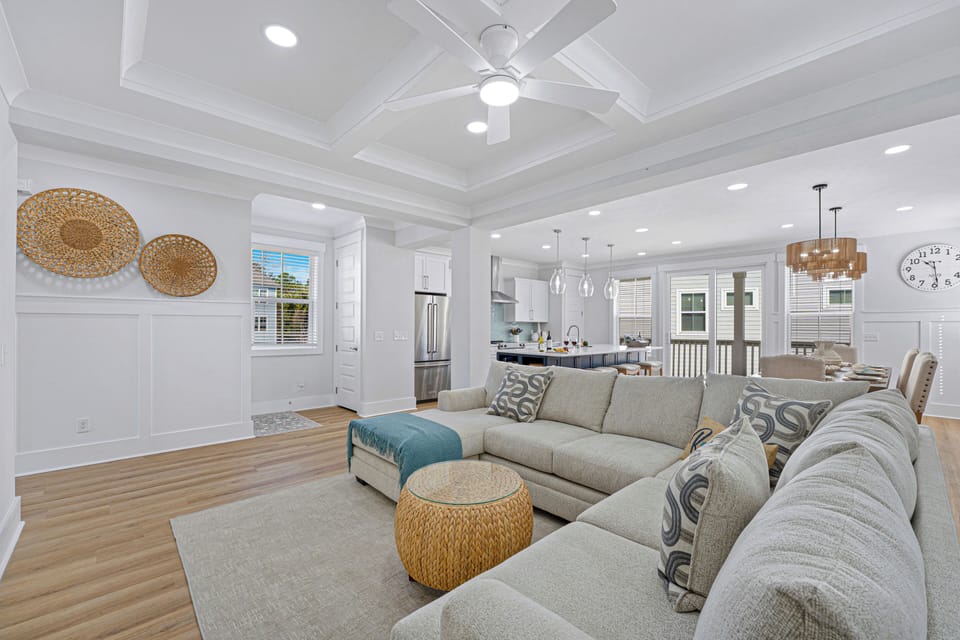The main family room features a cozy sectional, Smart TV, and access to the back balcony—ideal for relaxing or entertaining.
