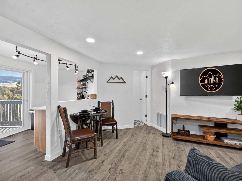 There is also a small dining table and a window into the kitchen area. 