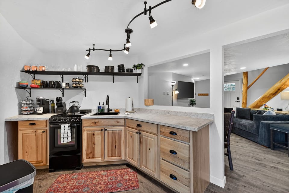 The kitchen is fully stocked with cookware & utensils, including a coffee bar with cream and sugar.