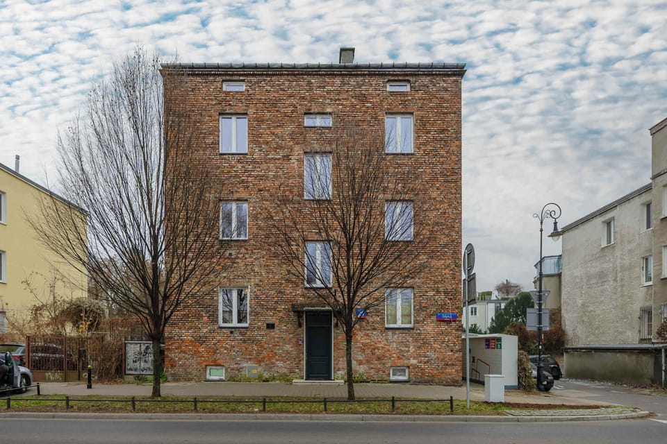 Charming exterior view of the building surrounded by greenery.