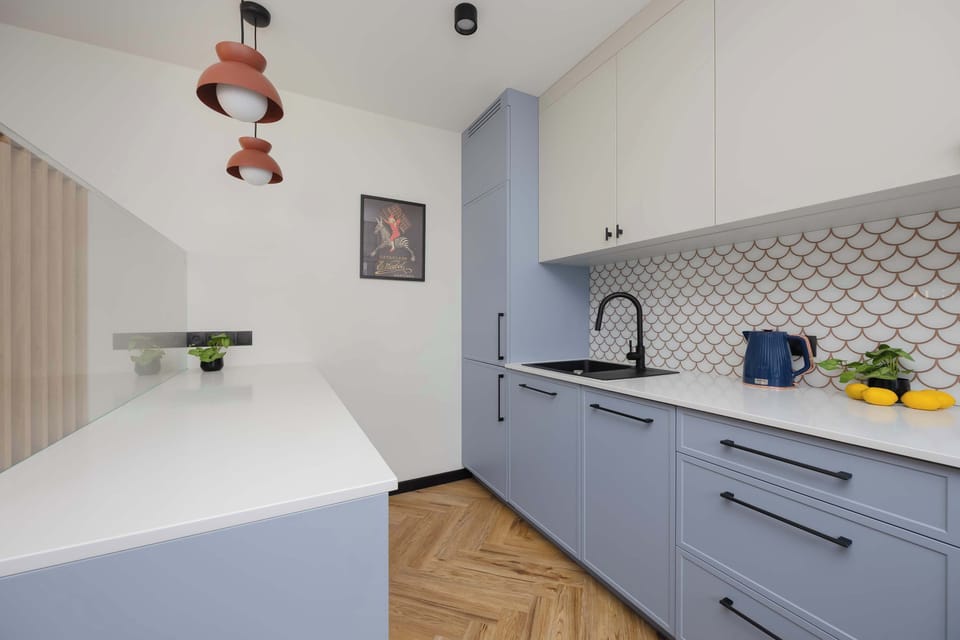 The sleek design of the kitchenette blending seamlessly with the living area.