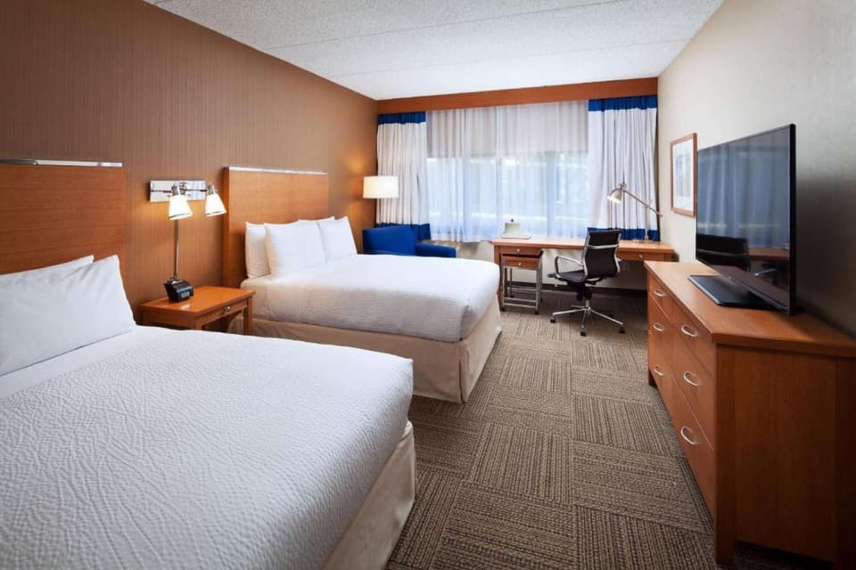Two Queen beds with TV and working area