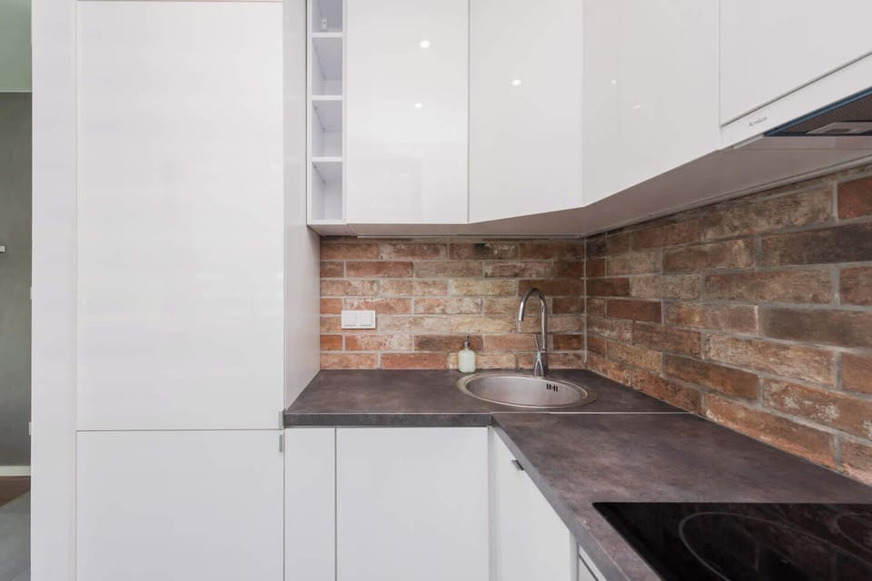 The sleek design of the kitchenette blending seamlessly with the living area.