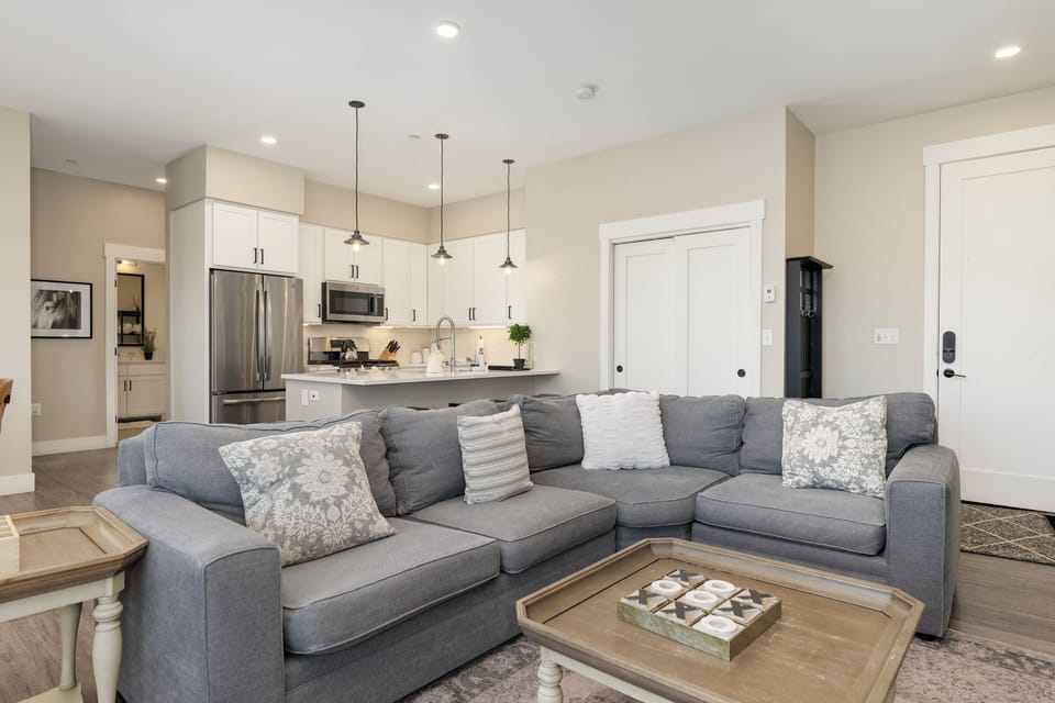 Sink into your plush sectional sofa and enjoy the open-concept elegance connecting your living space to the modern kitchen.