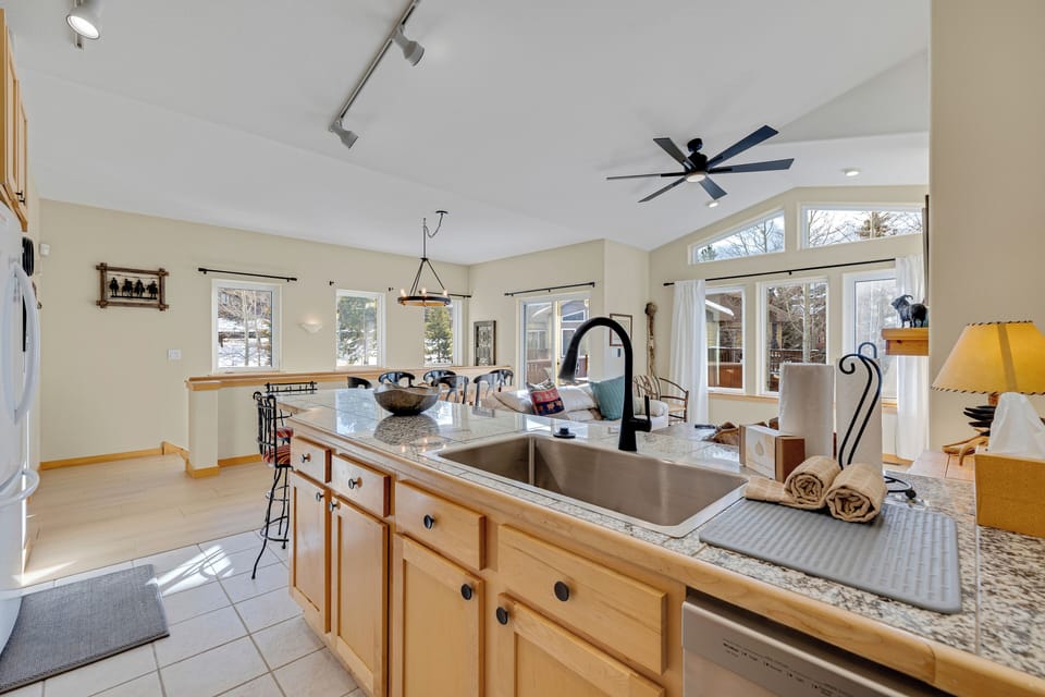 Your open-concept kitchen flows seamlessly into the living space, where you'll love preparing meals with granite counters and warm wood cabinetry.