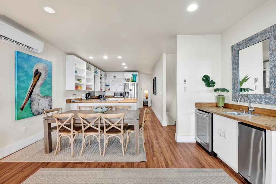 The living room has a wet bar with sink, standalone ice maker and mini fridge