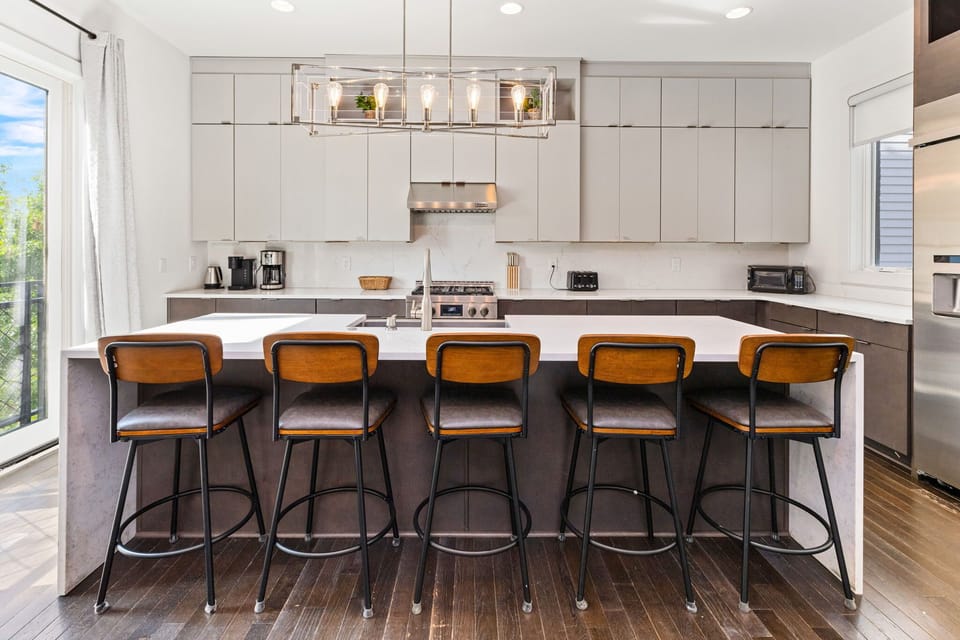  Modern elegance awaits in this spacious kitchen with sleek cabinetry and stylish seating!