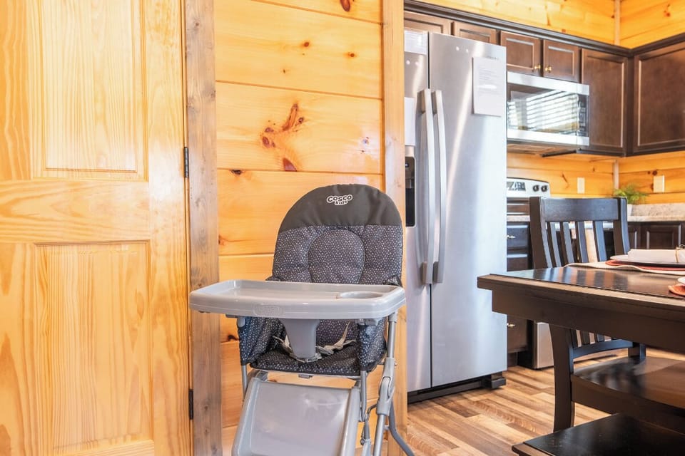 Your family's mountain retreat features a fully equipped kitchen with modern appliances and thoughtful baby amenities for stress-free family meals.