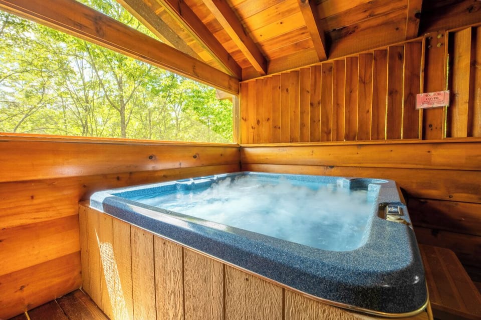 Sink into warm, bubbling waters while gazing at lush forest views from your private hot tub—a perfect spot to unwind and reconnect with nature.