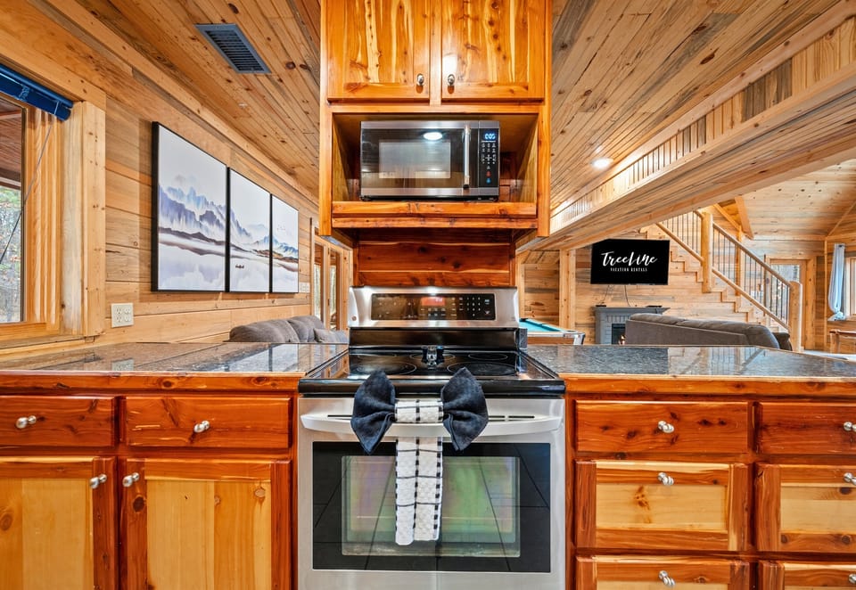 Rustic cabinetry paired with modern appliances blends cabin character with everyday convenience.