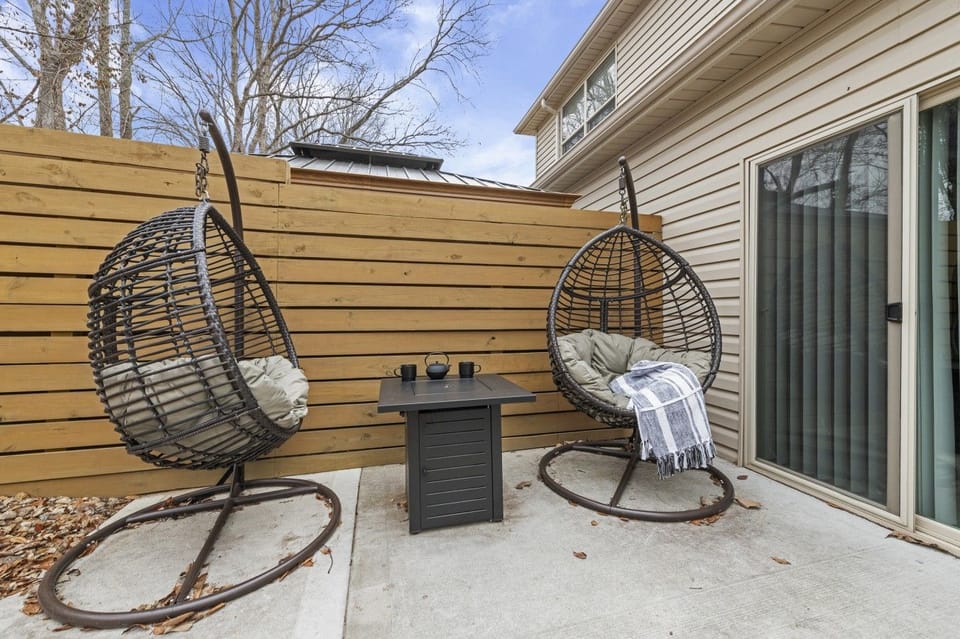 A little extra room to unwind. One of the two private backyards features rocking egg chairs—a cozy spot for coffee, conversation, or a quiet moment outside.