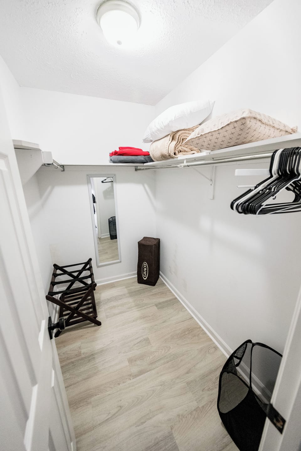 Walk-in closet with pack-n-play, extra pillows and blankets.
