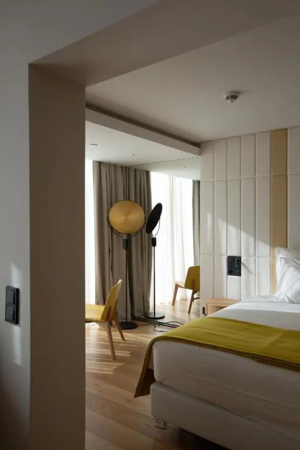 Bask in golden-hour glow beside the window-side chairs.