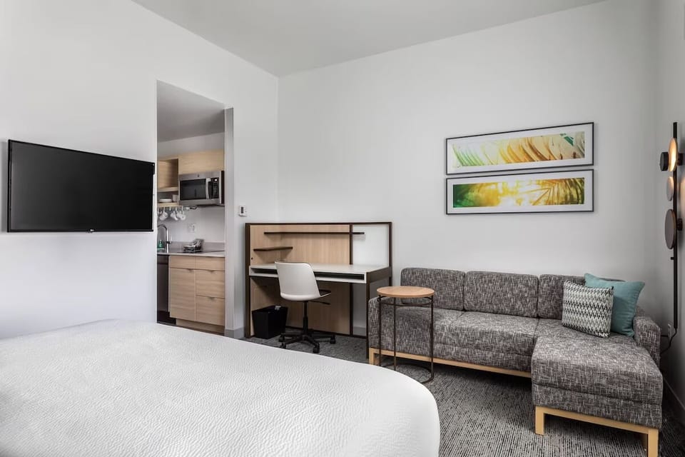 Settle in with TV, workspace, and easy kitchenette access.