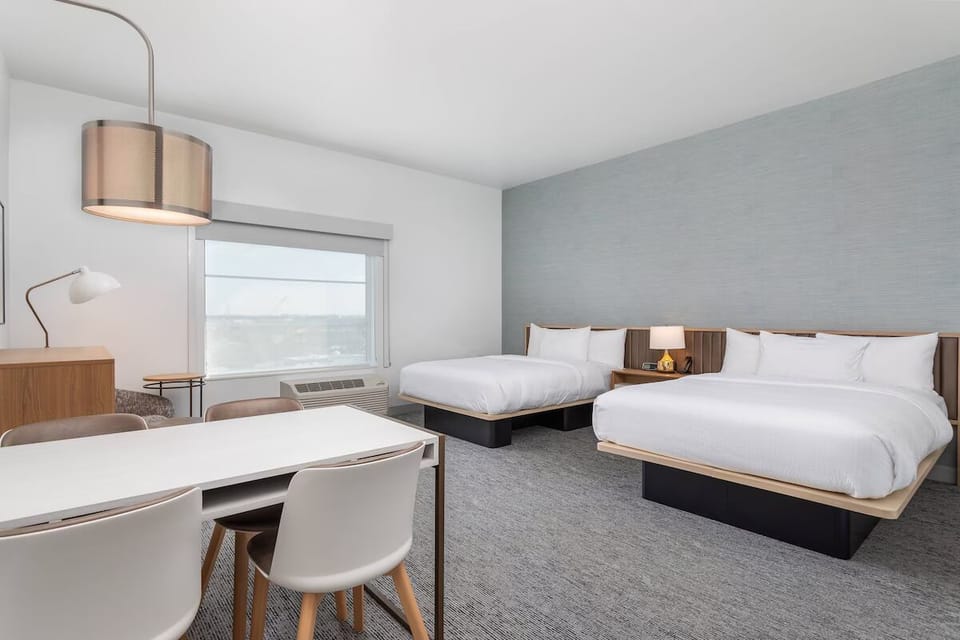 Relax together in a spacious room with multiple plush beds.