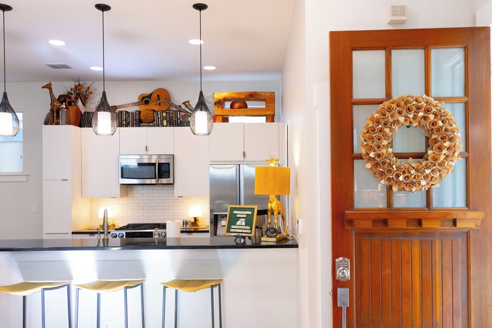 Step into your stylish kitchen with gleaming counters, modern appliances, and charming pendant lighting that creates the perfect cooking atmosphere.