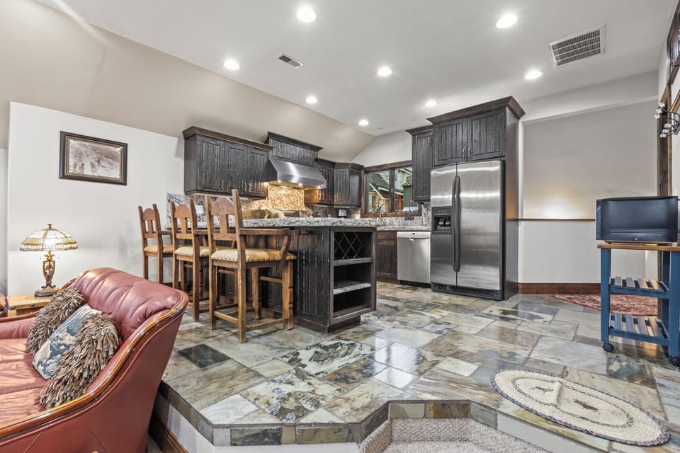 Your spacious open-concept kitchen invites culinary adventures with granite counters, stainless steel appliances, and cozy seating.