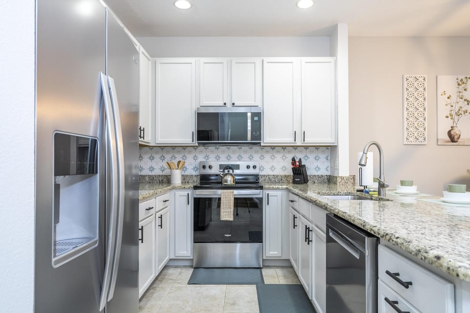 Modern kitchen with sleek appliances and granite countertops