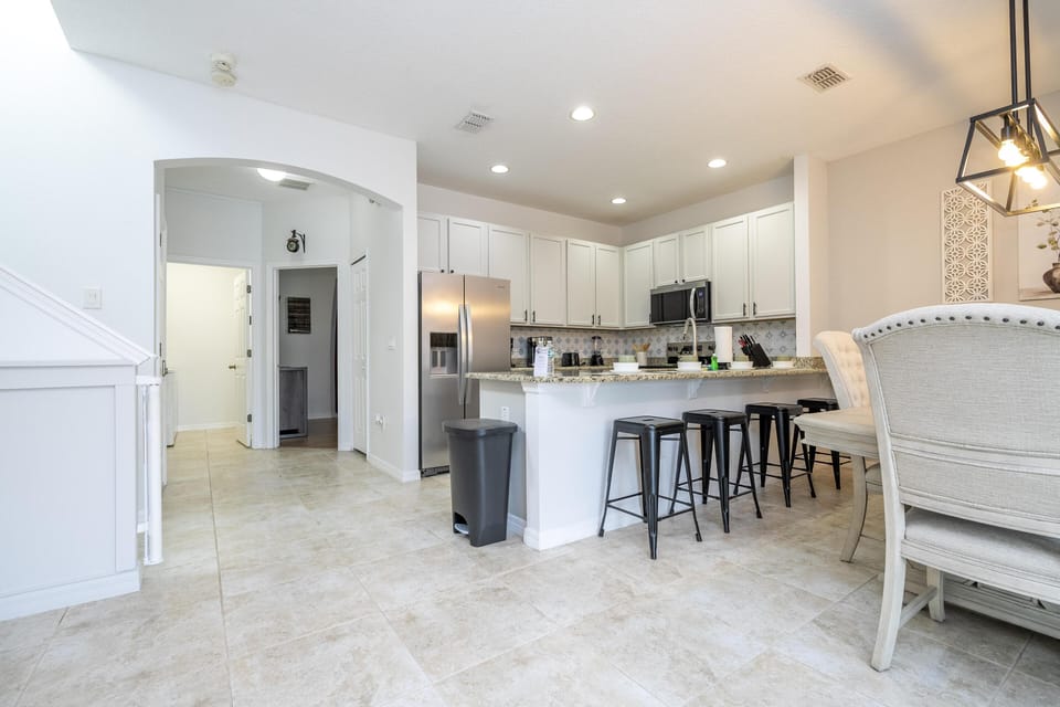Bright, open kitchen with sleek island and cozy dining area