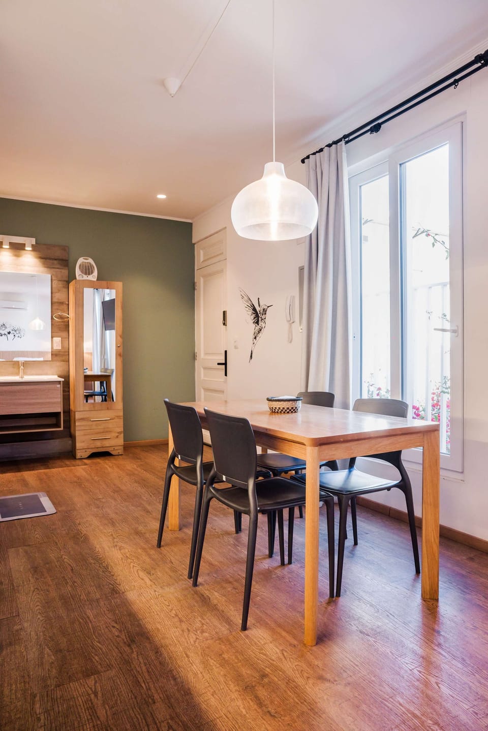 Cozy dining area with stylish decor and ample natural light, perfect for intimate meals.