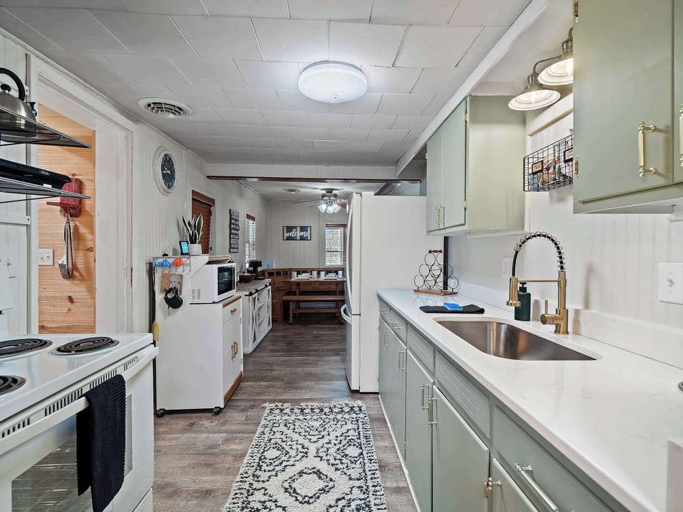 Spacious kitchen w/ long counters, bar seating & open layout for easy cooking flow