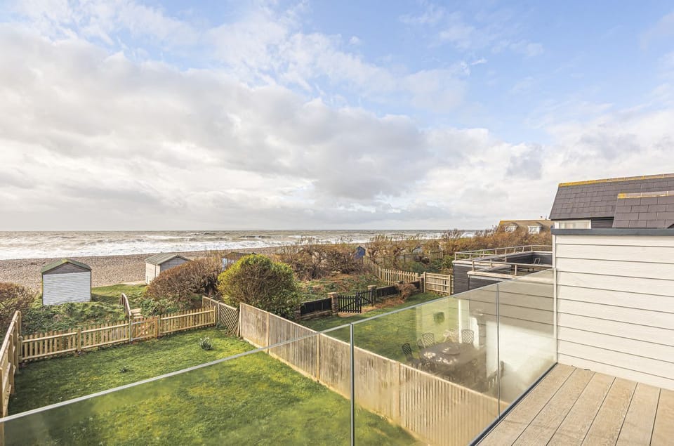 Balcony with breath-taking views of the beach and sea beyond