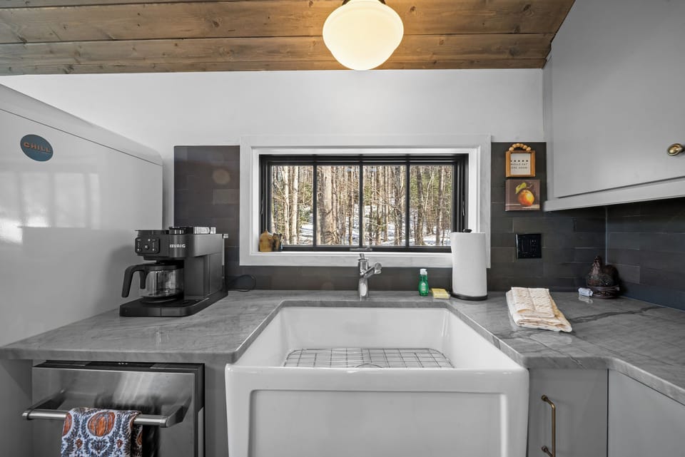 Large Basin Sink and Kitchen Window with a Beautiful Wooded View