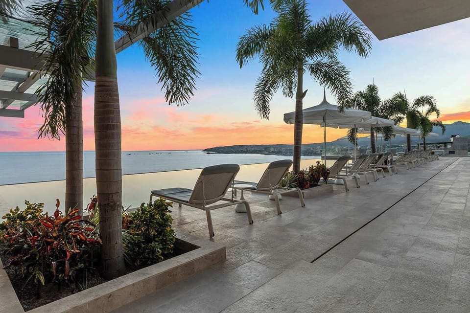 Rooftop infinity pool at sunset 