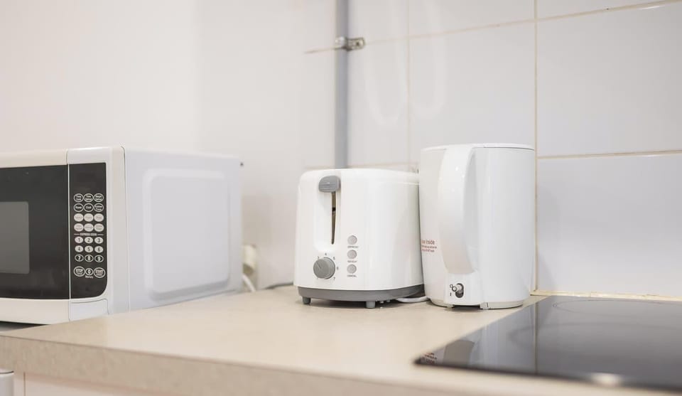 Convenient countertop area with toaster and kettle, ideal for breakfast and light meals.
