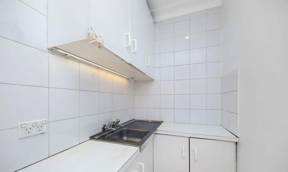 Modern and functional kitchen with sleek cabinetry, cooktop, and ample counter space.