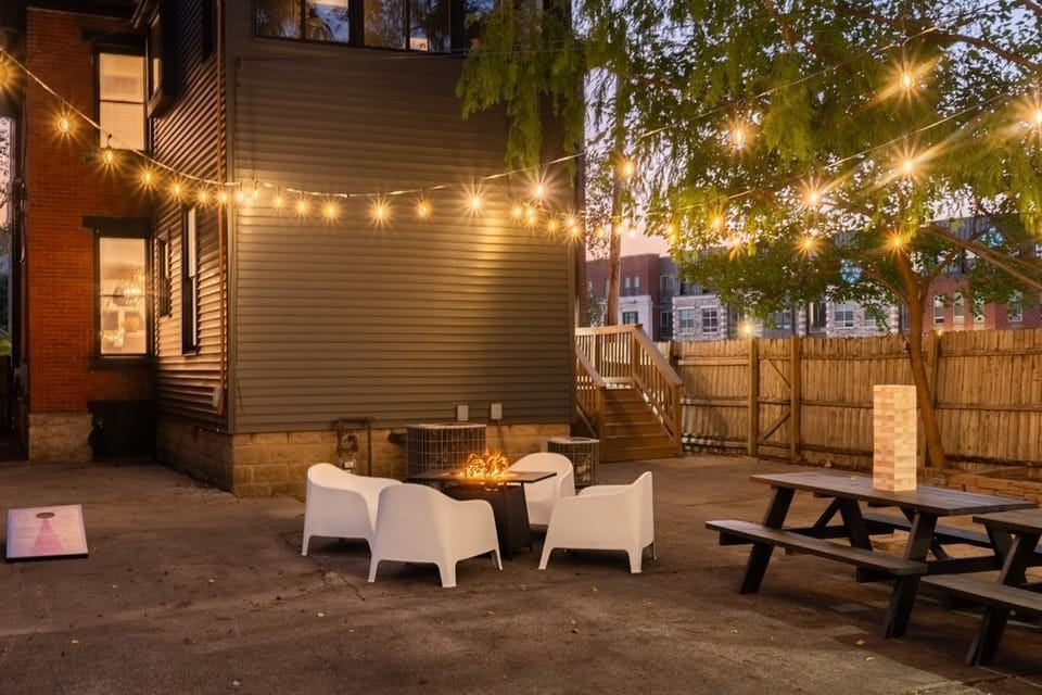 Backyard fun awaits — enjoy string lights, giant Jenga, a grill, and a picnic table perfect for gatherings.